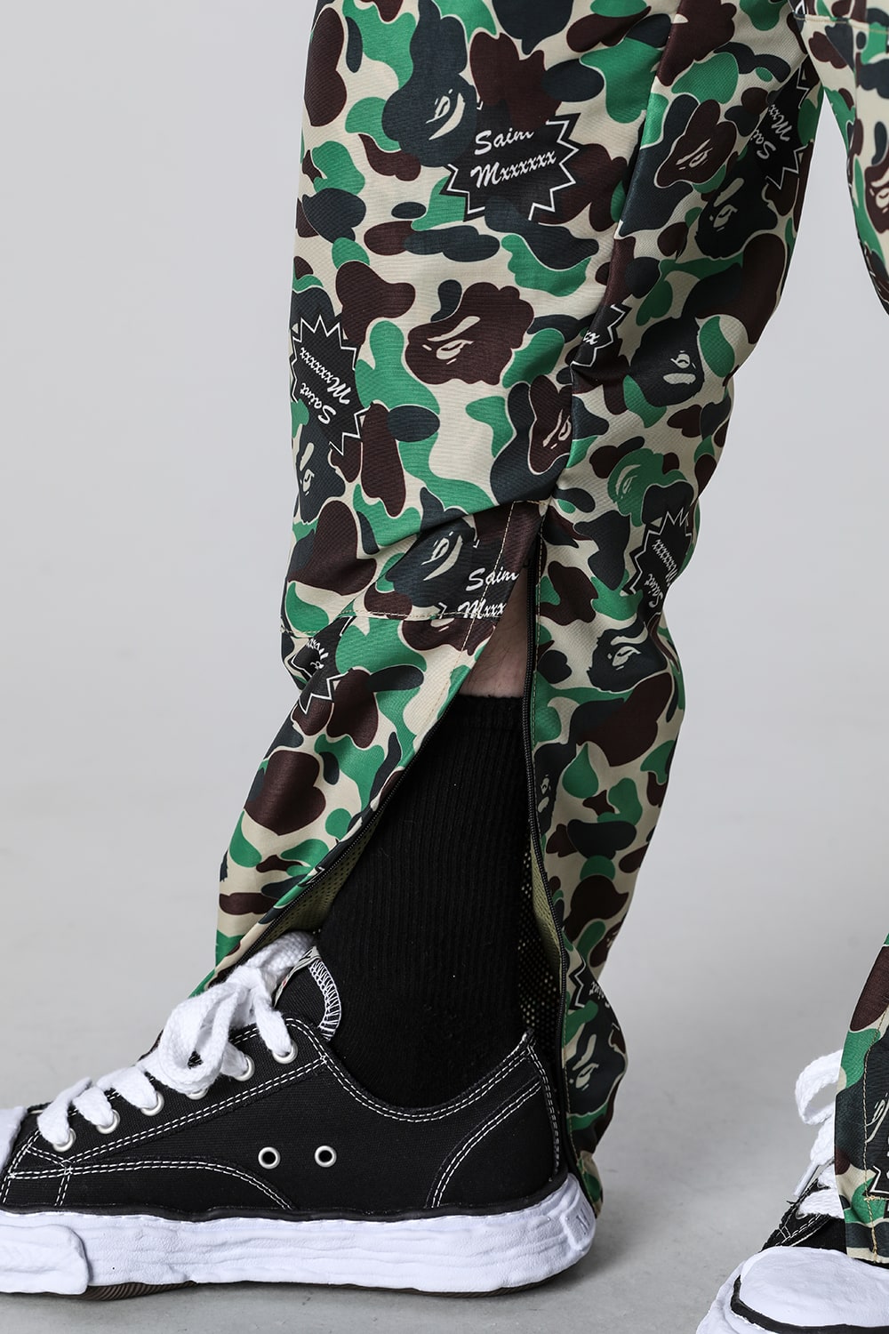 A BATHING APE® × SAINT Mxxxxxx STAPE Track Pants